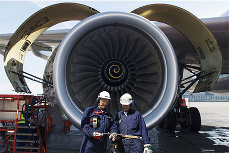 techs working on jet engine