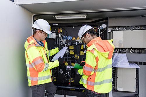 electricians working on electrical panel